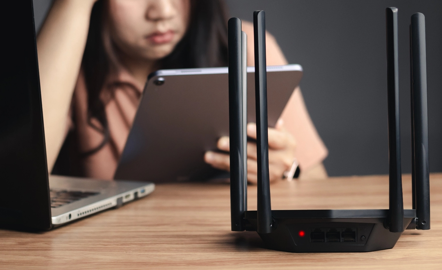 frustrated-woman-troubleshooting-home-wifi-router-issue@2x