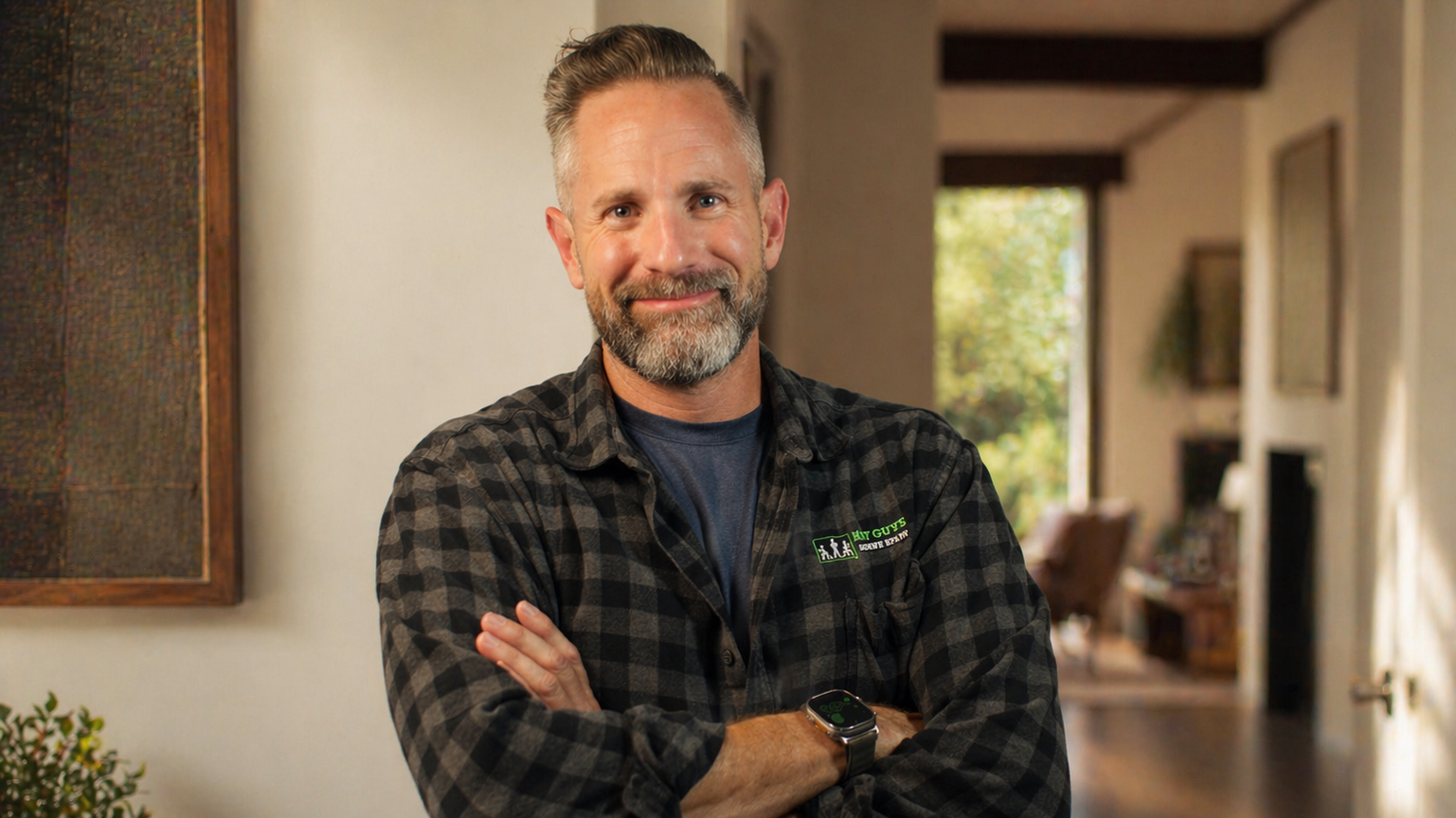 Bryan Talkie smiling at the home property  can see the halway in the background