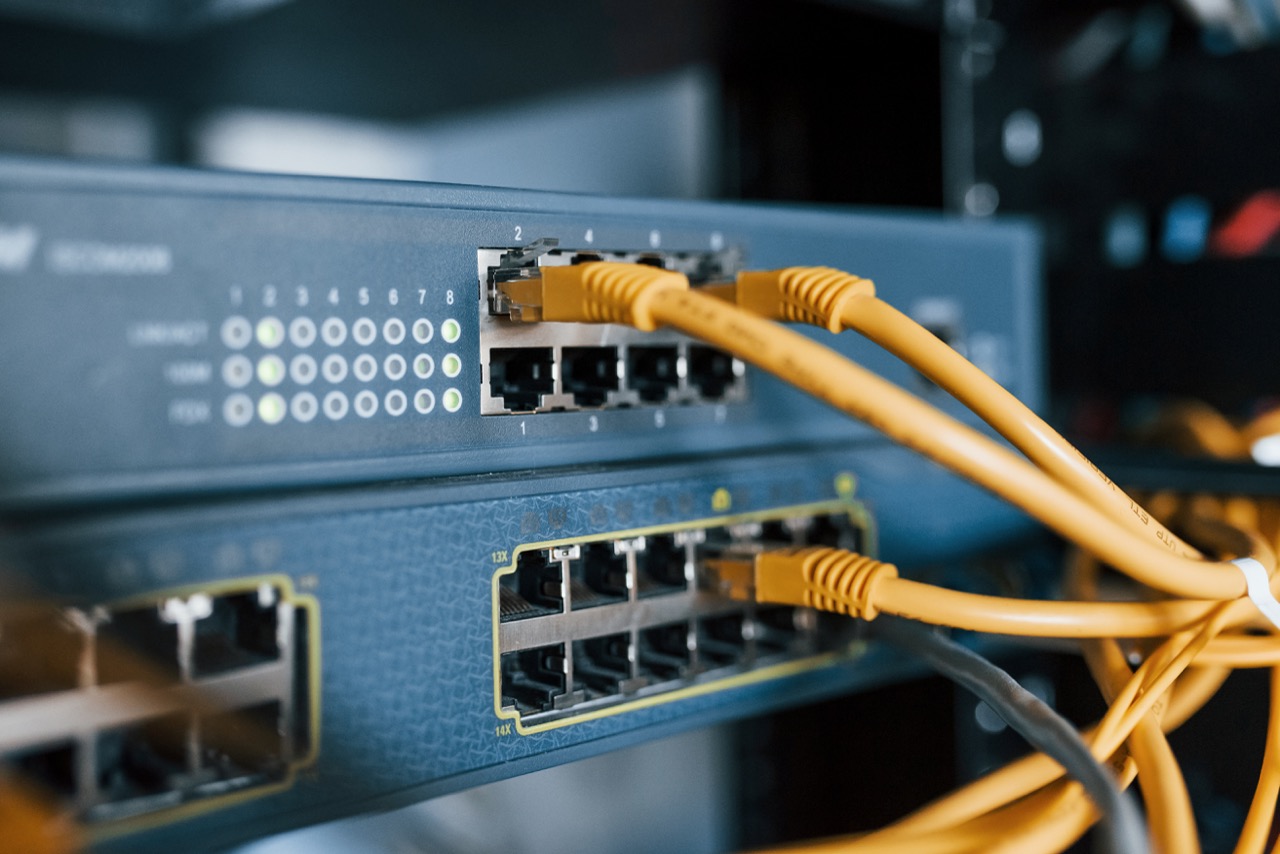 Up close image of networking switch and yelow cables